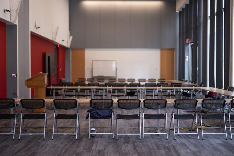 Seating configuration with tables and chairs in a 'U' shape.