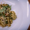Plated pesto gnocchi with Parmesan cheese